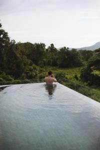 a man sitting in a pool of water at Serene Vita Retreat in Phumĭ Ŏng Char +41 photos