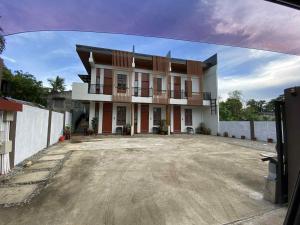 a large white building with a large driveway at three x apartelle in Tagbilaran City