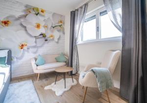 a living room with two chairs and a window at ENGEL in Arnfels in Arnfels