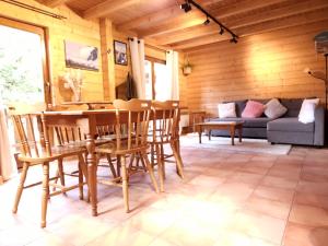 a living room with a table and chairs and a couch at Chalet du Bief , Morillon 4-6 pers in Morillon