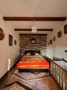 a bedroom with a bed and a brick wall at Apartments "Old house Mustafic" in Bar