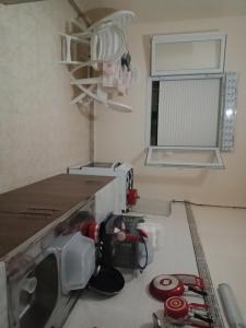a kitchen with a coffee maker on a counter at حمودي شقق مجهزة للكراء مرحبا بالجميع in Skikda