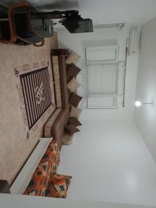 an overhead view of a room with stairs and a window at حمودي شقق مجهزة للكراء مرحبا بالجميع in Skikda