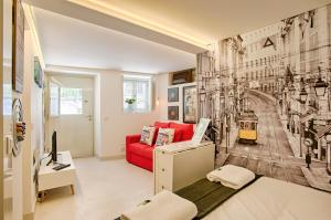 a living room with a red couch and a wall mural at BmyGuest - Alfama Boutique Apartment in Lisbon