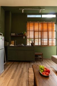 a kitchen with a bowl of fruit on a table at PINhome - PIN Boutique Stays in Ho Chi Minh City