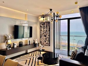 a living room with a view of the ocean at CSJ Apartment Sea View Vung Tau - Căn Hộ CSJ Tầm nhìn biển , Tháp Tam Thắng Vũng Tàu in Vung Tau