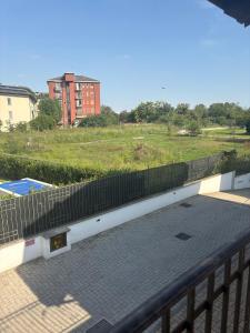 a balcony with a fence next to a field at La casetta di San siro in Milan