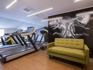a gym with treadmill and treadles in a room at Mercure Krakow Stare Miasto in Kraków