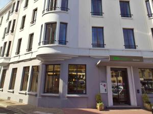 a white building with a store in front of it at ibis Styles Moulins Centre in Moulins