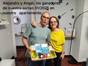a man and a woman holding a tray of food at Apartamento turístico CasacheloCangas en el corazón de Cangas, PLAYAS, CIES,VIGO in Cangas de Morrazo