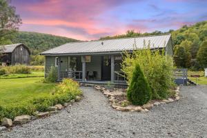 a small house with a garden and a barn at Adventure Basecamp! Cabin near all Attractions! in Beaver Dams