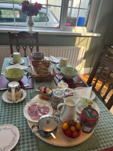 a table with plates and bowls of food on it at Killala B&B Avondale in Killala +15 photos