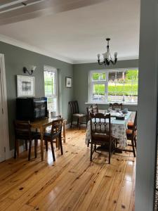 a living room with a dining room table and chairs at Killala B&B Avondale in Killala