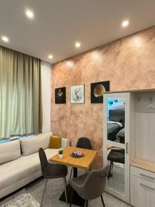 a living room with a couch and a table at Aura Apartment Herne in Herne +4 photos