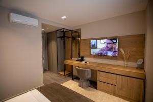 a room with a television on a wall at Villa Five Hotel in Lushnjë +32 photos