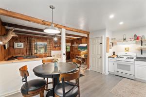 a kitchen and dining room with a table and chairs at Adventure Basecamp! Cabin near all Attractions! in Beaver Dams
