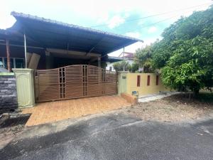 a wooden fence in front of a house at ZzHomestay 