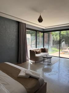 a bedroom with a bed and a couch and a table at AD Villa in Marrakesh +43 photos