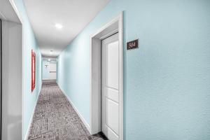 a hallway with a exit sign on a blue wall at 1511 Seas The Day- Batiki West Unit #504 condo in Fort Myers Beach