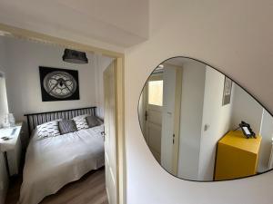 a bedroom with a mirror on the wall at Apartmán ve dvoře in Žatec +10 photos