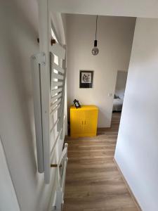 a staircase in a room with a yellow cabinet at Apartmán ve dvoře in Žatec