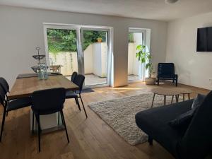 a living room with a dining room table and a couch at Großzügiges Apartment in Biberach an der Riss in Biberach an der Riß