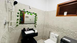 a bathroom with a sink and a mirror at Paradise Walk Stay in Nikawatawana +13 photos
