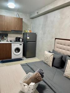 a living room with a couch and a kitchen at Hideaway Haven Studio in Suba +33 photos