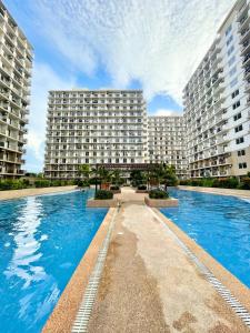 a swimming pool in front of two large buildings at Hideaway Haven Studio in Suba