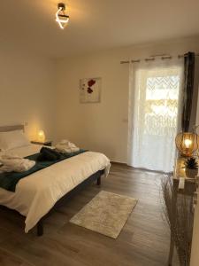 a bedroom with two beds and a large window at Exceptionnel appartement avec vue mer in Vendres-Plage