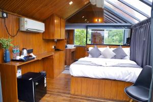 a bedroom with a large bed in a house at Nyast Valley Resort by Autumleafs, Goa in Arpora