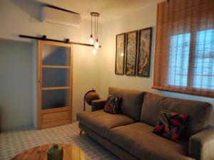 a living room with a couch and a table at Verde Oliva apartamento in Vejer de la Frontera +67 photos