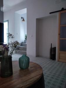 a room with a table with a green vase on it at Verde Oliva apartamento in Vejer de la Frontera