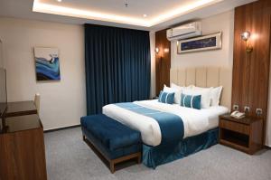 a hotel room with a large bed and a chair at فندق امان - أحد رفيدة in Ahad Rafidah +89 photos