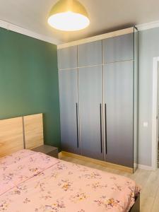 a bedroom with a bed and a large closet at Толеби in Astana +1 photo