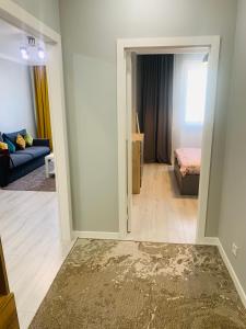 a living room with a door open to a bedroom at Толеби in Astana