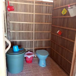 a bathroom with a toilet and two trash cans at Paradise Raja Ampat in Dayang +47 photos