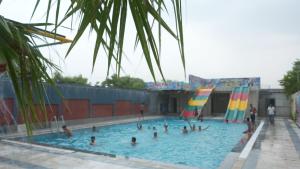a group of people in a swimming pool at Hotel Holiday Fun Resort in Prāgpura
