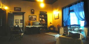 a living room with yellow walls and a television at Raj Kot in Nainital
