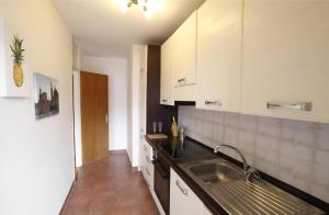 a kitchen with a sink and a counter top at Melide Apartments Lake Lugano close to Swissminiatur & Private Parking on Request with Limited Availability in Melide +10 photos