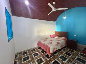 a bedroom with a bed and a ceiling fan at Al Salam Camp in Luxor
