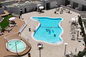 an overhead view of a swimming pool with two people in it at Luxury Suites With Balcony And Jacuzzi At Sea Side By Rently in Eilat