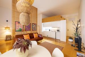 a living room with a couch and a chandelier at Porto Ribeira Flat in Porto