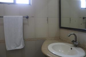 a bathroom with a sink and a mirror at New Pak Guest House in Islamabad