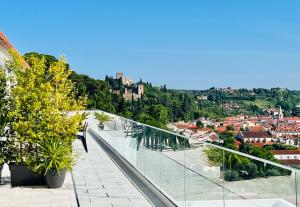 a balcony with a view of a city at Vila Pombal Tomar - Luxury Apartment with private pool and Castle View in Tomar