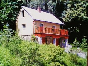 a house with a balcony on top of a hill at Chata u Kempu in Jedovnice