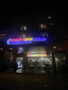 a restaurant with a neon sign on the front of it at Comfy Inn Manila-Kalaw in Manila +17 photos
