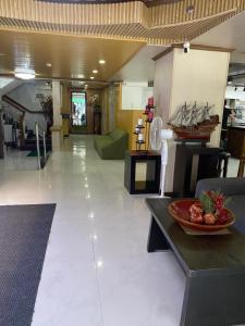 a lobby with a bowl of fruit on a table at Comfy Inn Manila-Kalaw in Manila