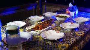 a table with plates and bowls of food on it at Paradise Raja Ampat in Dayang