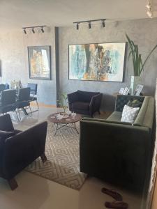 a living room with a couch and chairs and a table at Luxury Apartment COP 30 in Belém